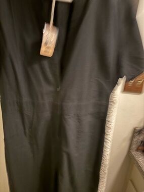 Black buttoned down jumpsuit with Short Sleeves. Roomy and wide leg. Never worn